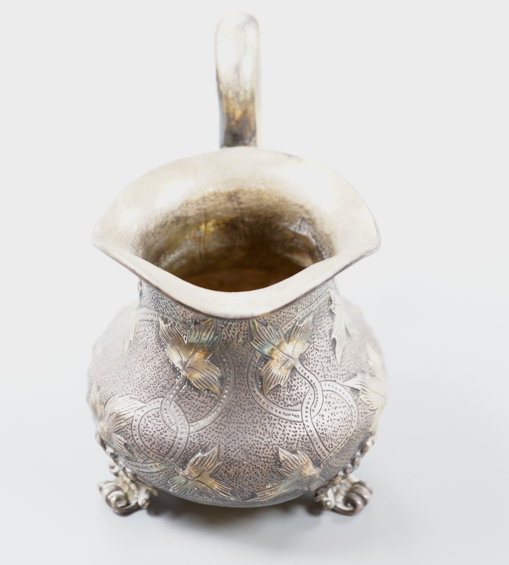 A 19th century Russian gilt white metal cream jug, indistinct marks, 94mm, 109 grams.